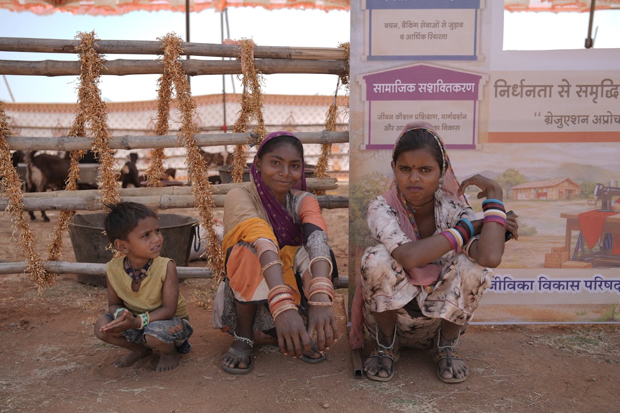 Indian village women and a child at a rural community event with cultural attire.
